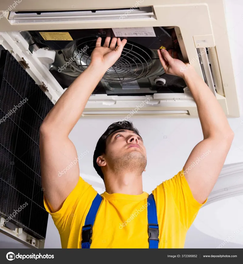 HVAC technician servicing air conditioning unit